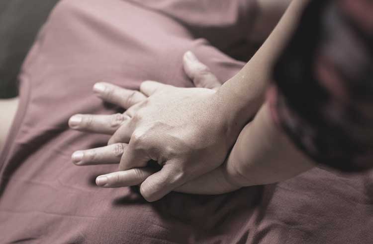 hands performing hands-only CPR on chest hands performing hands-only CPR on chest